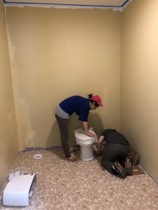 Bi lin and brother Jin are installing toilet.